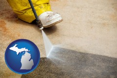 michigan map icon and pressure washing a concrete surface