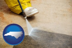 north-carolina map icon and pressure washing a concrete surface