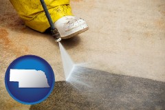 nebraska map icon and pressure washing a concrete surface