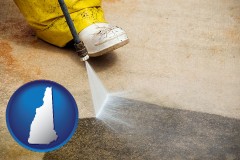 new-hampshire map icon and pressure washing a concrete surface