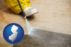 new-jersey map icon and pressure washing a concrete surface