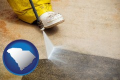 south-carolina map icon and pressure washing a concrete surface