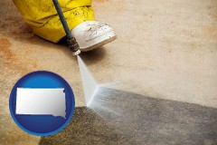 south-dakota map icon and pressure washing a concrete surface