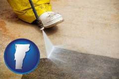 vermont map icon and pressure washing a concrete surface
