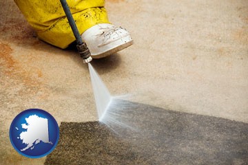 pressure washing a concrete surface - with Alaska icon