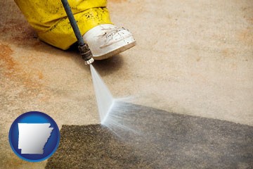 pressure washing a concrete surface - with Arkansas icon
