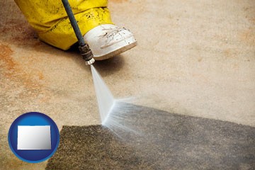 pressure washing a concrete surface - with Colorado icon