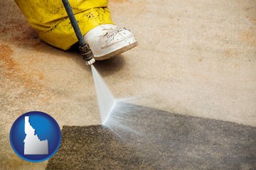 pressure washing a concrete surface - with Idaho icon