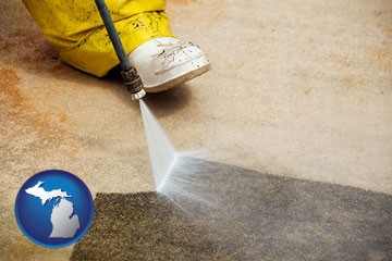 pressure washing a concrete surface - with Michigan icon