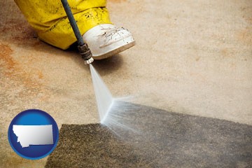 pressure washing a concrete surface - with Montana icon